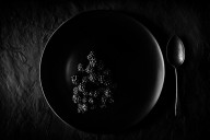 23229576 blackberries-on-black-plate-johan-swanepoel